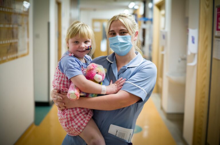 Nurse in mask holding a patient
