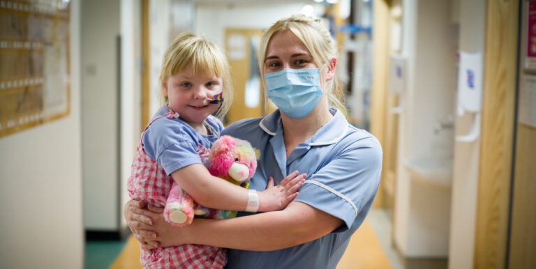 Nurse in mask holding a patient